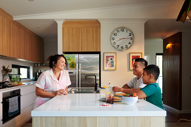 a photo of a mum, her husband and kid in the kitchen